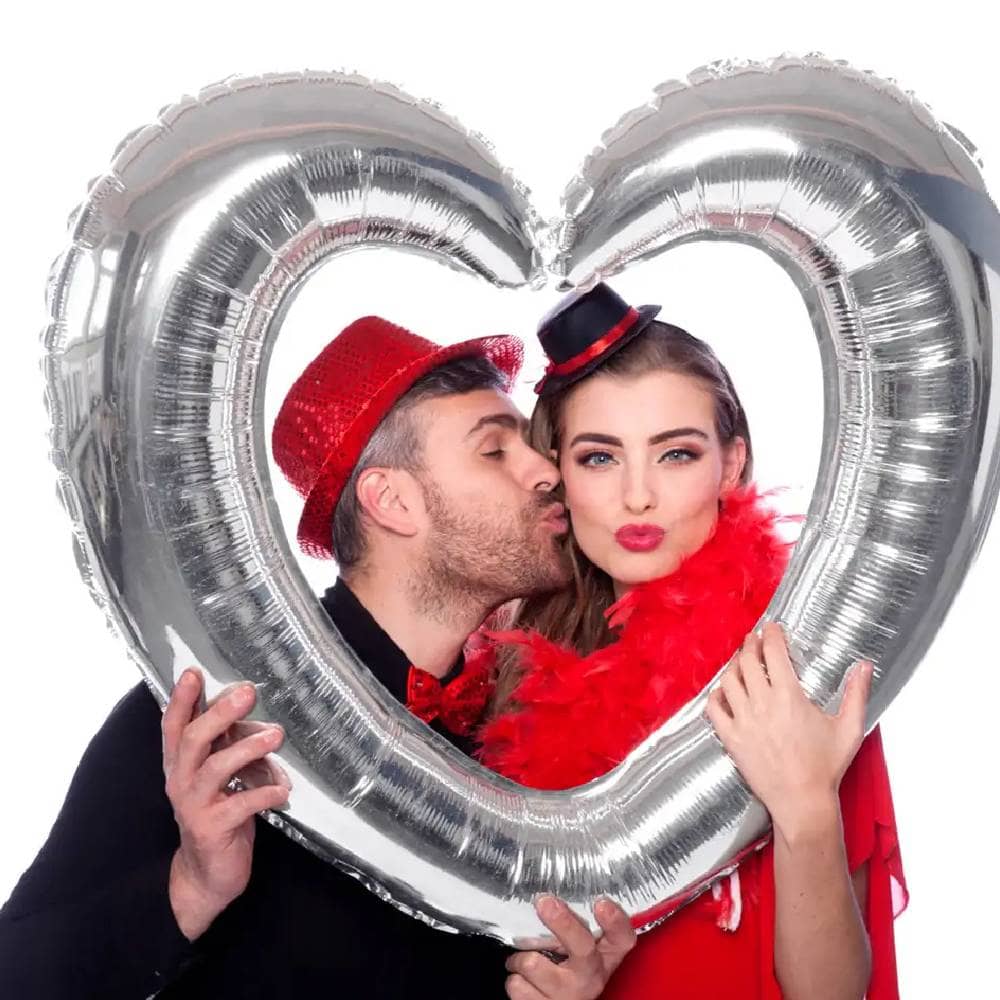 Man en vrouw poseren in een Hartvormig foto frame van folie