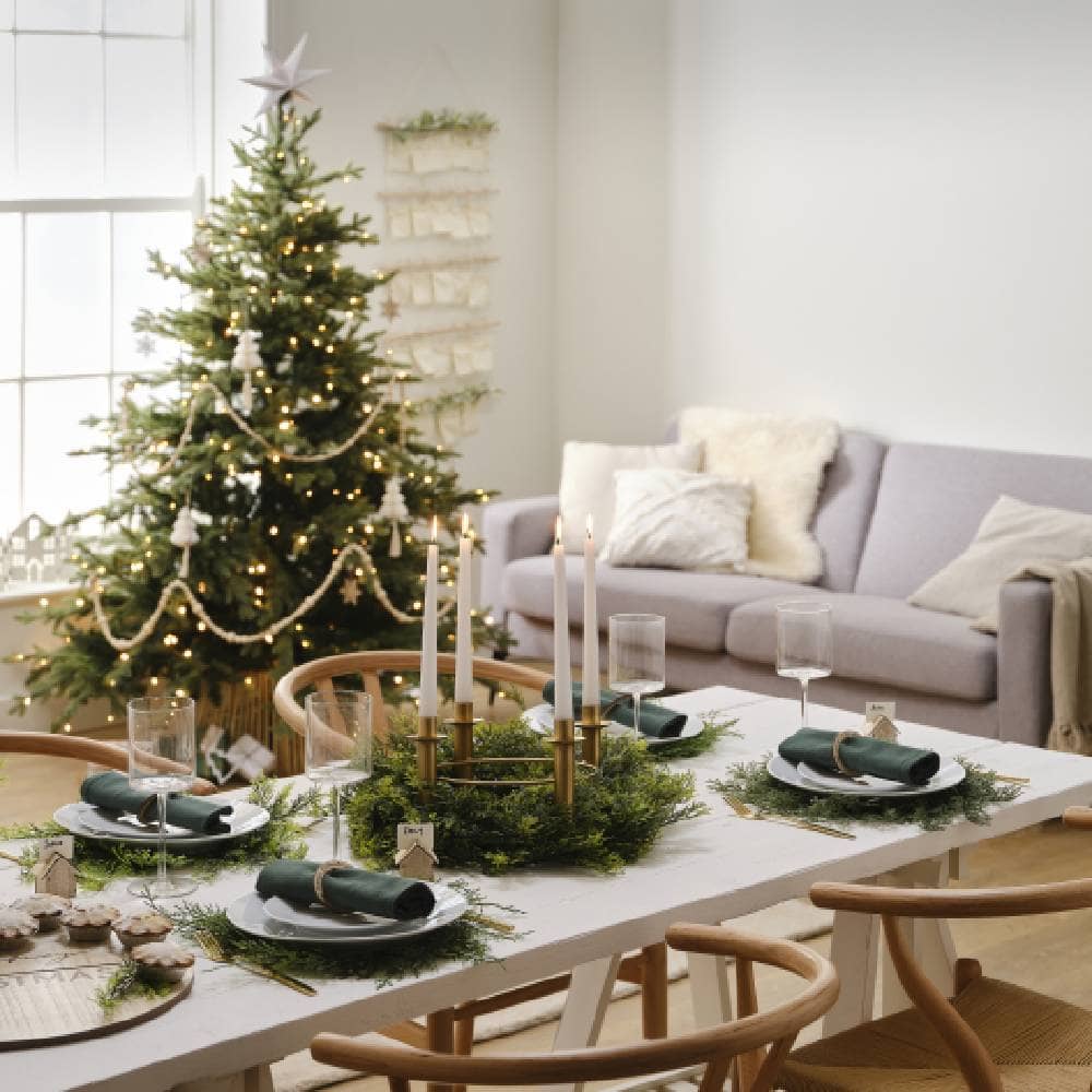 Kamer met kerstboom en gedekte tafel voor kerstdiner