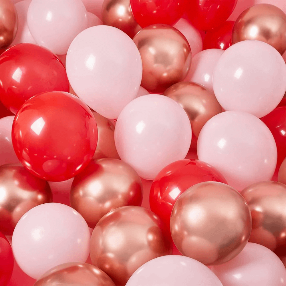 Lichtroze, rose gouden en rode ballonnen
