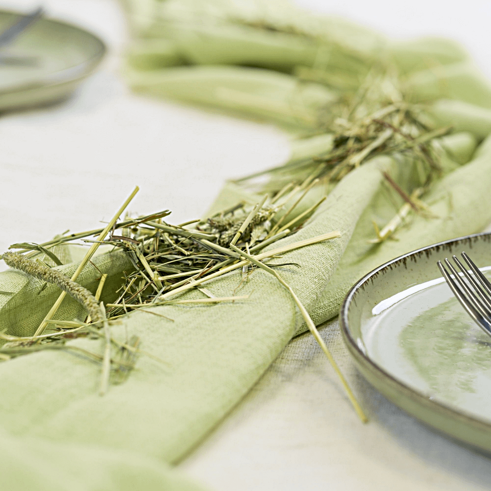 Saliegroene tafelloper bedekt met stro