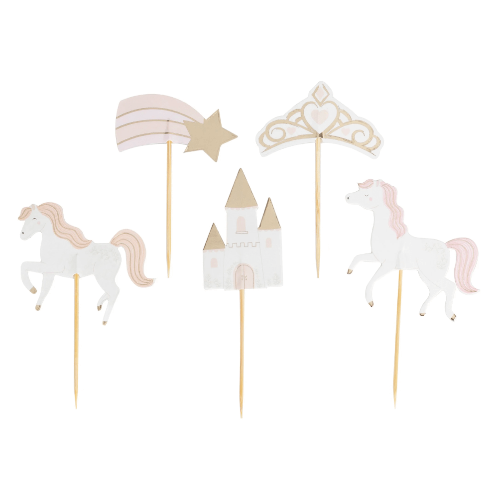 Roze, perzikkleurige, witte en gouden cupcaketoppers in de vorm van paarden, een kasteel, een kroon en een vallende ster