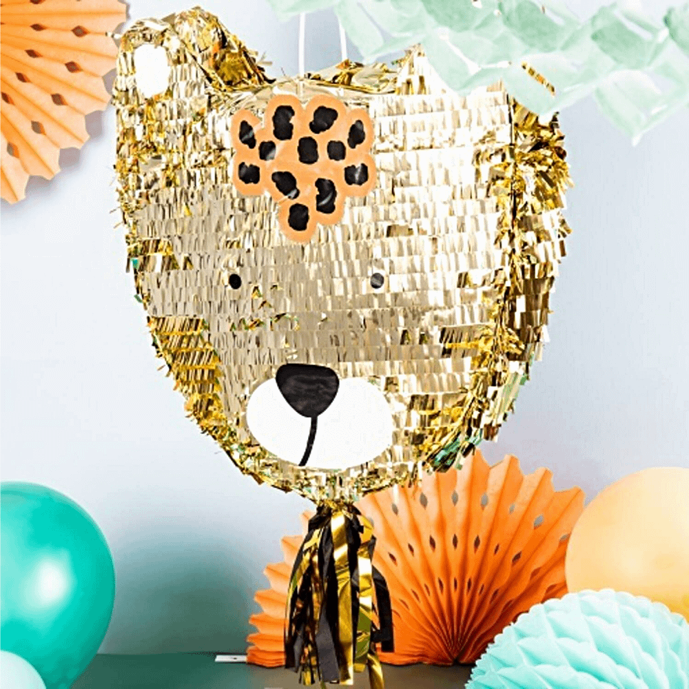 Pinata in de vorm van een luipaard met gouden tassels hangt voor waaiers in het oranje en blauw