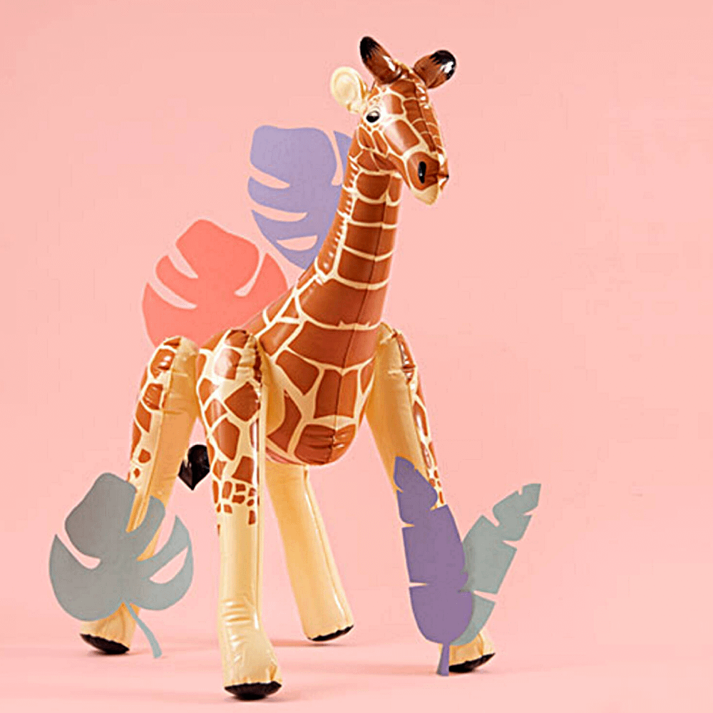 Opblaas giraffe staat voor een roze achtergrond