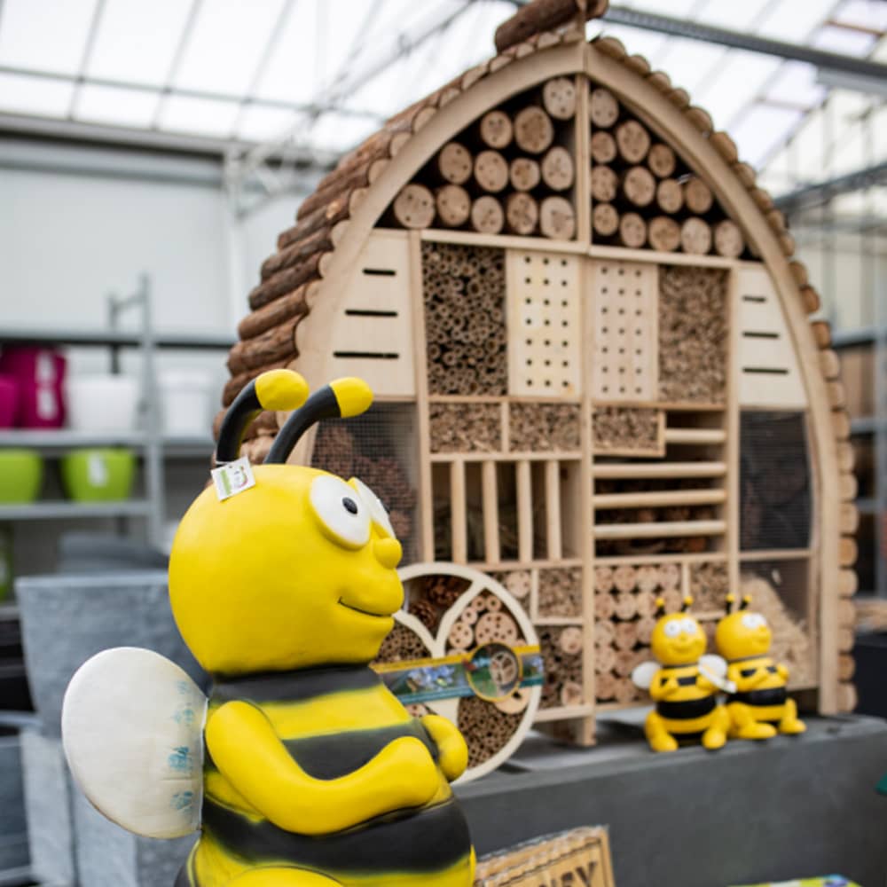 Groot insectenhotel met afmetingen erbij en bijenfiguren in winkel